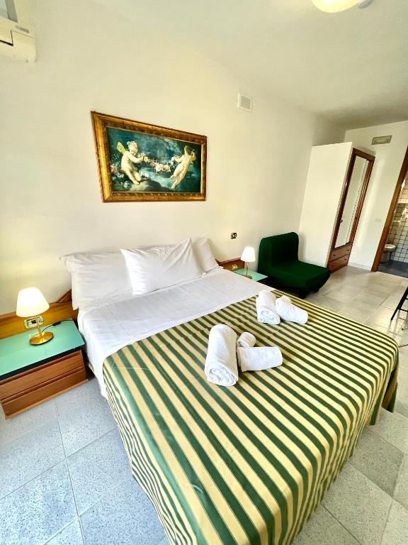 Postel nebo postele na pokoji v ubytování Hotel Minerva