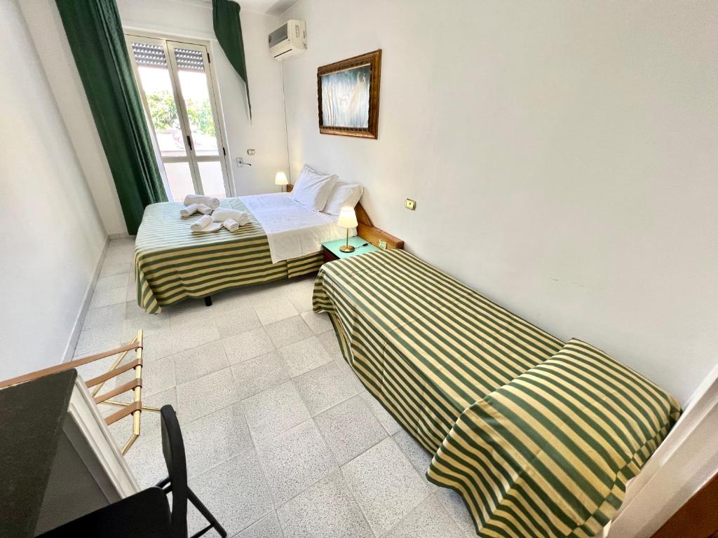 Postel nebo postele na pokoji v ubytování Hotel Minerva