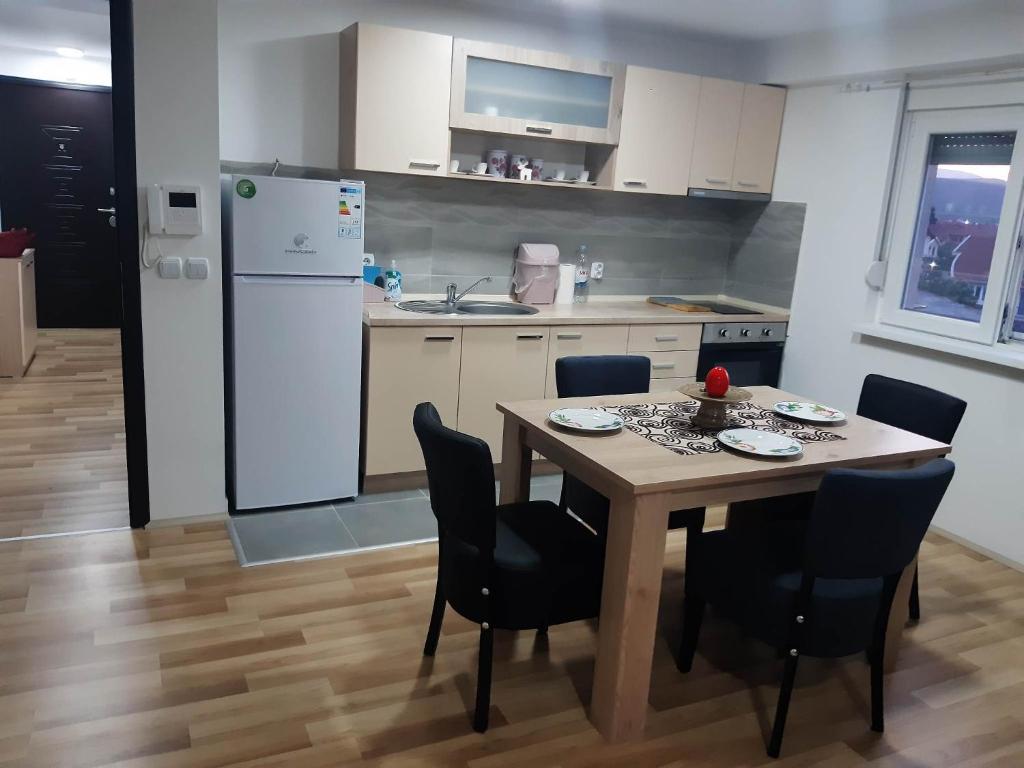 a kitchen with a table and chairs and a refrigerator at Apartments Josif in Gevgelija