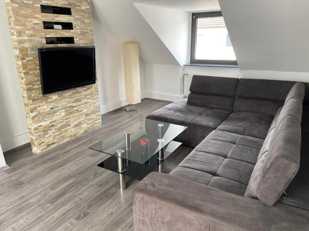a living room with a couch and a tv at Ferienwohnung in Essen in Essen