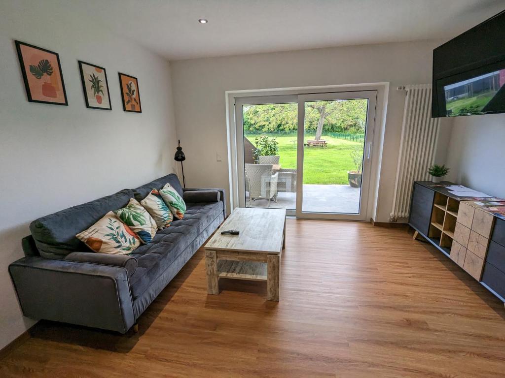 a living room with a couch and a coffee table at S'bahnhöfle Apartments in Ringsheim