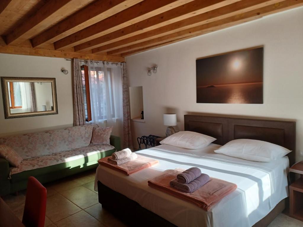a bedroom with a large bed and a couch at JR Luxury Guesthouse2 in Split