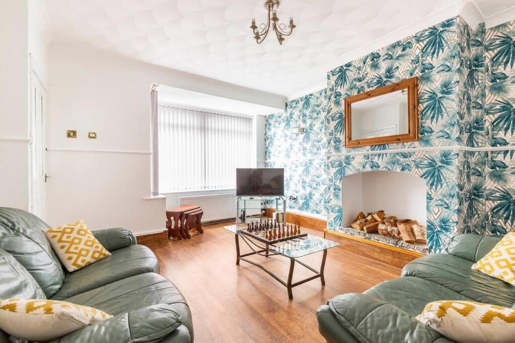 a living room with a couch and a fireplace at Memory Lane - beautifully renovated house close to motorway networks in Shevington