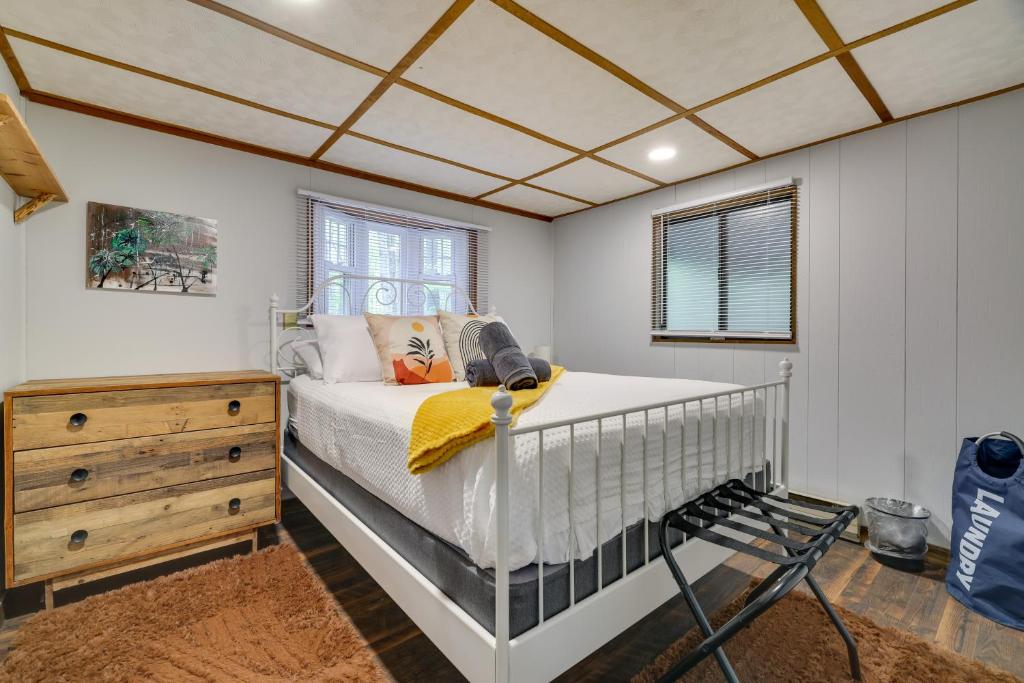 a bedroom with a crib and a wooden dresser at Hot Tub and Resort Amenities Pocono Lake Retreat! in Pocono Lake