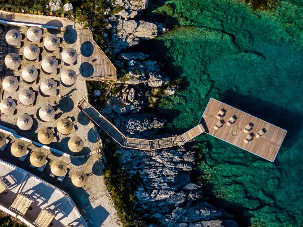 an overhead view of a beach with a pier and water at Aliv stone suites & spa in Agios Nikolaos