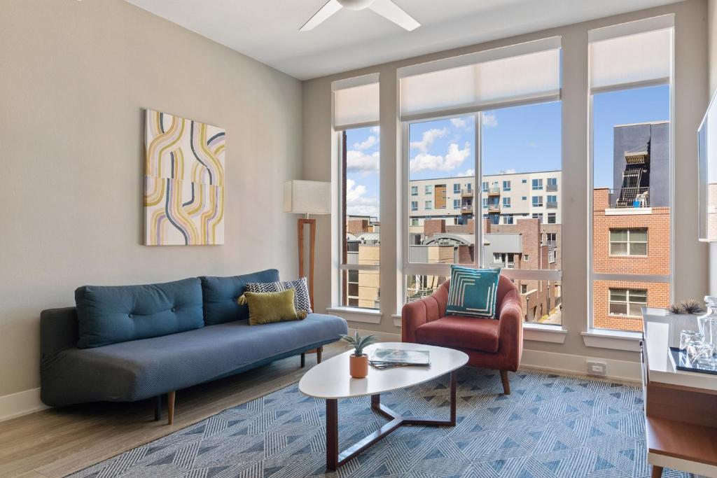 a living room with a couch and chairs and a window at Kasa Union Station Denver in Denver