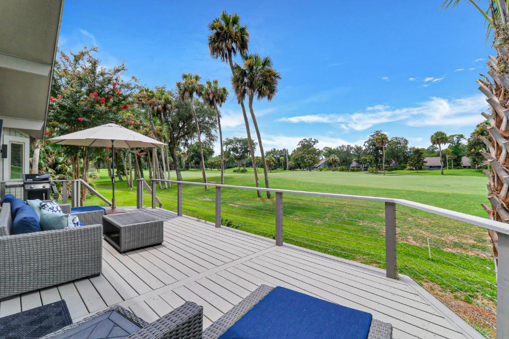 a deck with a view of a golf course at 7 Ginger Beer - Fairway Breeze in Hilton Head Island