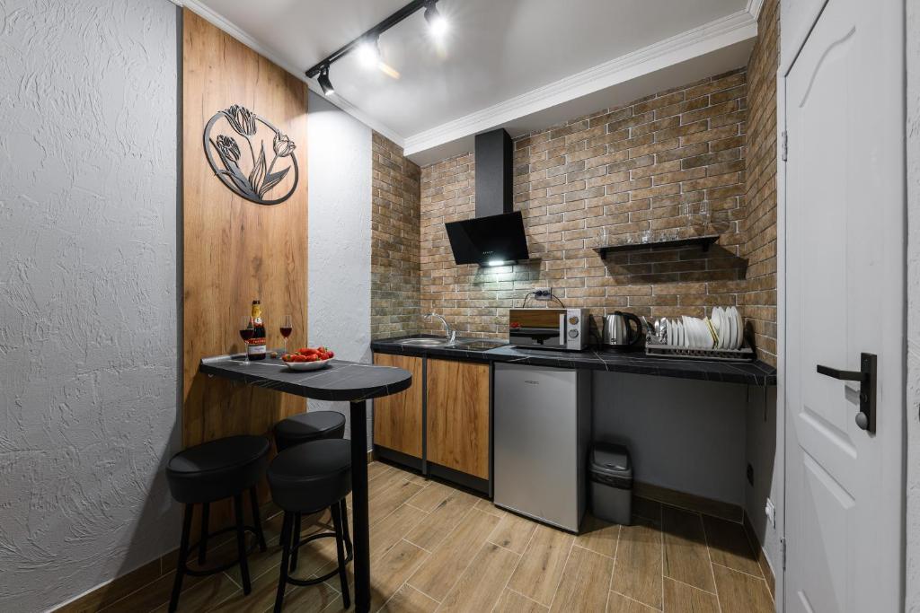 a small kitchen with a counter and stools at Нові затишні smart-квартири LеГо in Uzhhorod