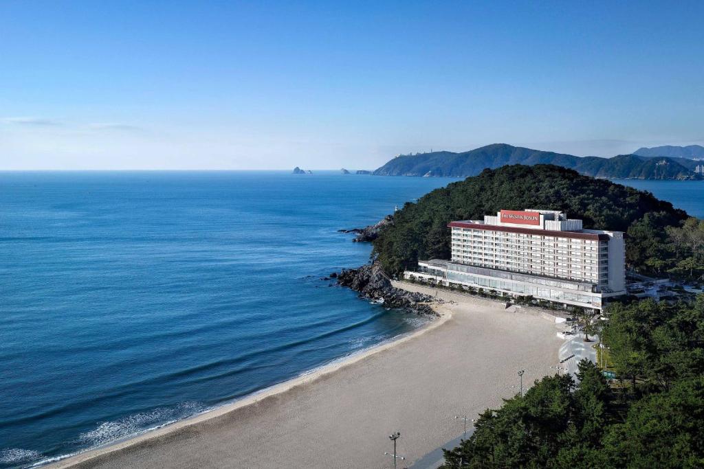 a hotel on a beach next to the ocean at The Westin Josun Busan in Busan