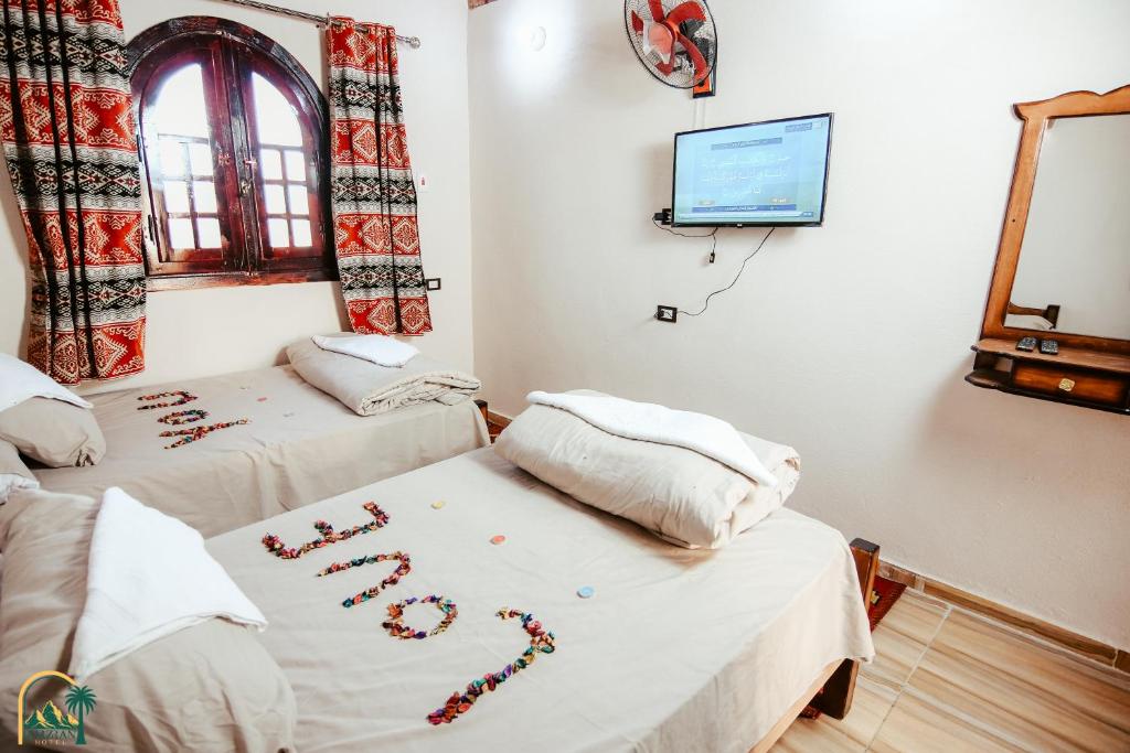 Postel nebo postele na pokoji v ubytování amzran hotel siwa
