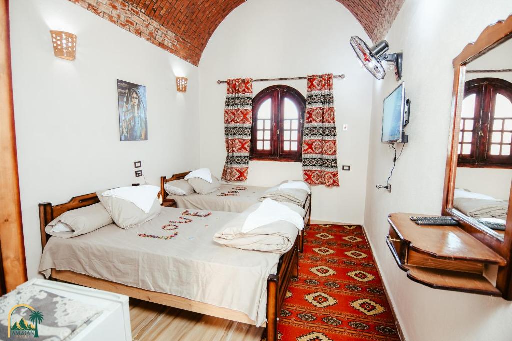 Postel nebo postele na pokoji v ubytování amzran hotel siwa