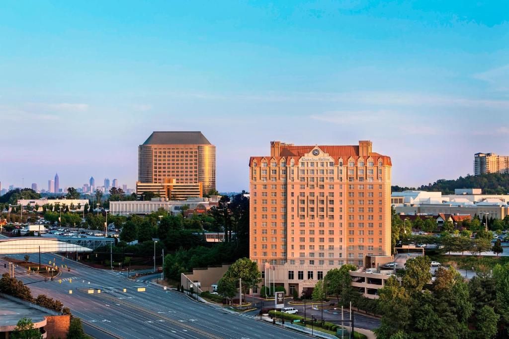 a city skyline with tall buildings and a freeway at Sheraton Suites Galleria Atlanta in Atlanta