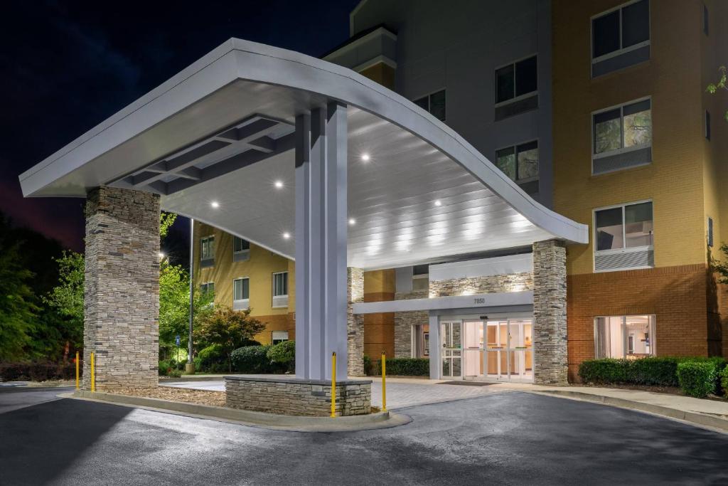 a building with a large white canopy over a parking lot at Fairfield Inn & Suites by Marriott Atlanta Stonecrest in Lithonia