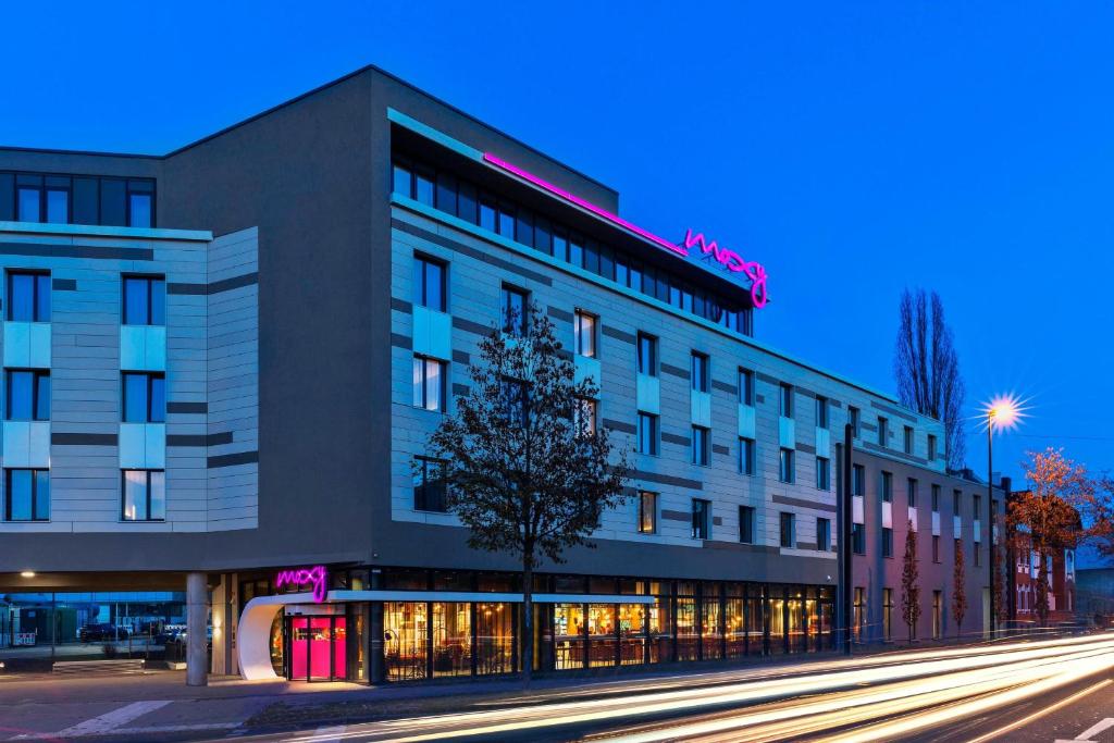 a building on a city street at night at Moxy Duesseldorf South in Düsseldorf