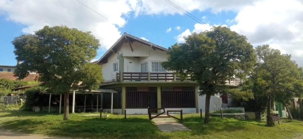 una casa con dos árboles delante de ella en departamento en villa gesell en Villa Gesell