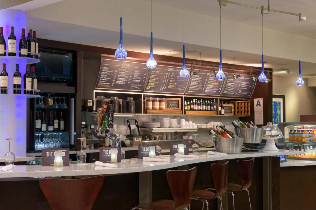 a bar with a counter with bottles of wine at Courtyard San Diego Old Town in San Diego