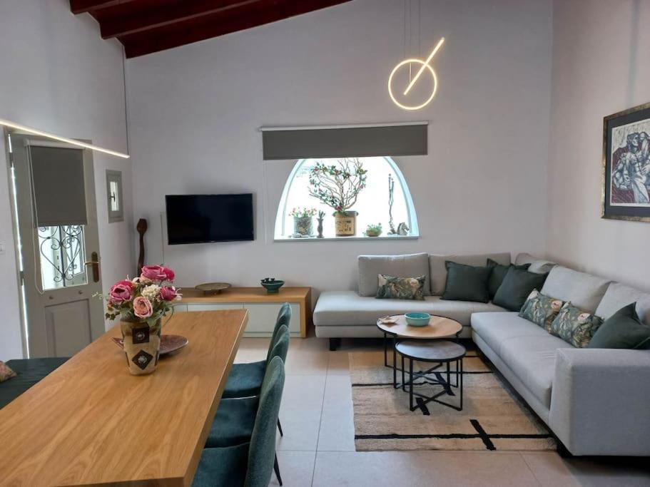 a living room with a couch and a table at Casa Petra in Nea Kydonia