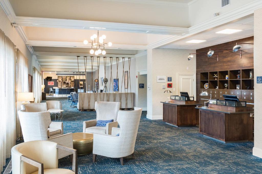 a lobby of a hotel with a table and chairs at Four Points by Sheraton Eastham Cape Cod in Eastham