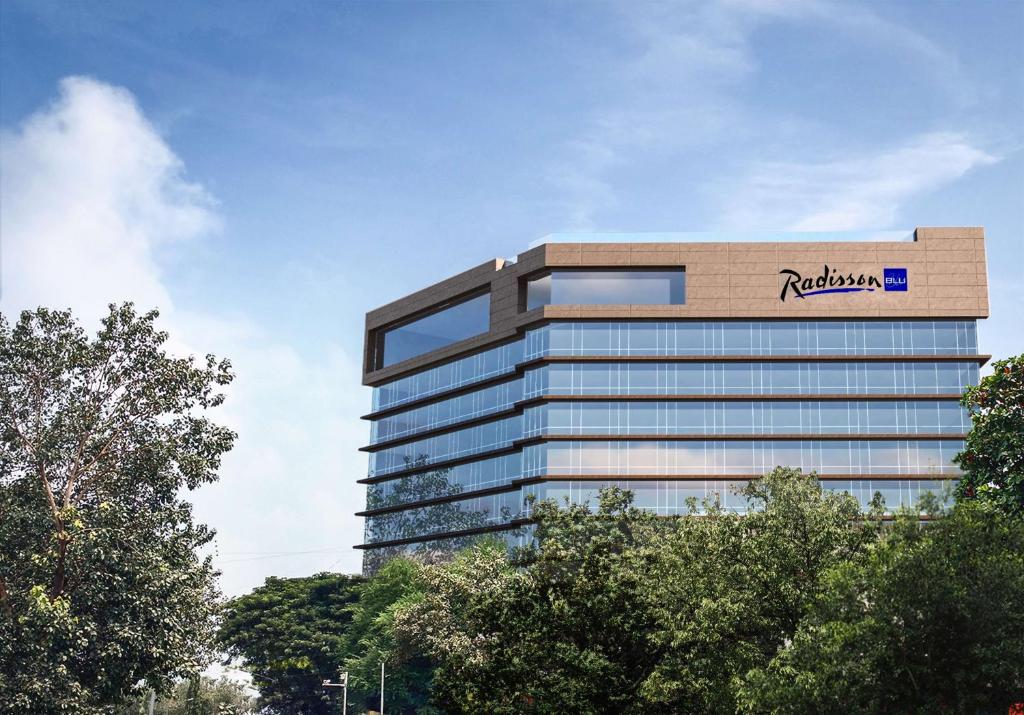 a building with a roelandauts sign on top of it at Radisson Blu Mumbai International Airport in Mumbai