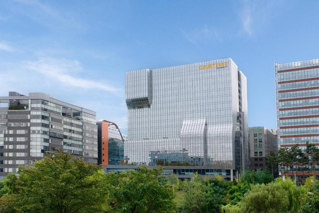 a building with a samsung sign on the side of it at Courtyard by Marriott Seoul Pangyo in Seongnam