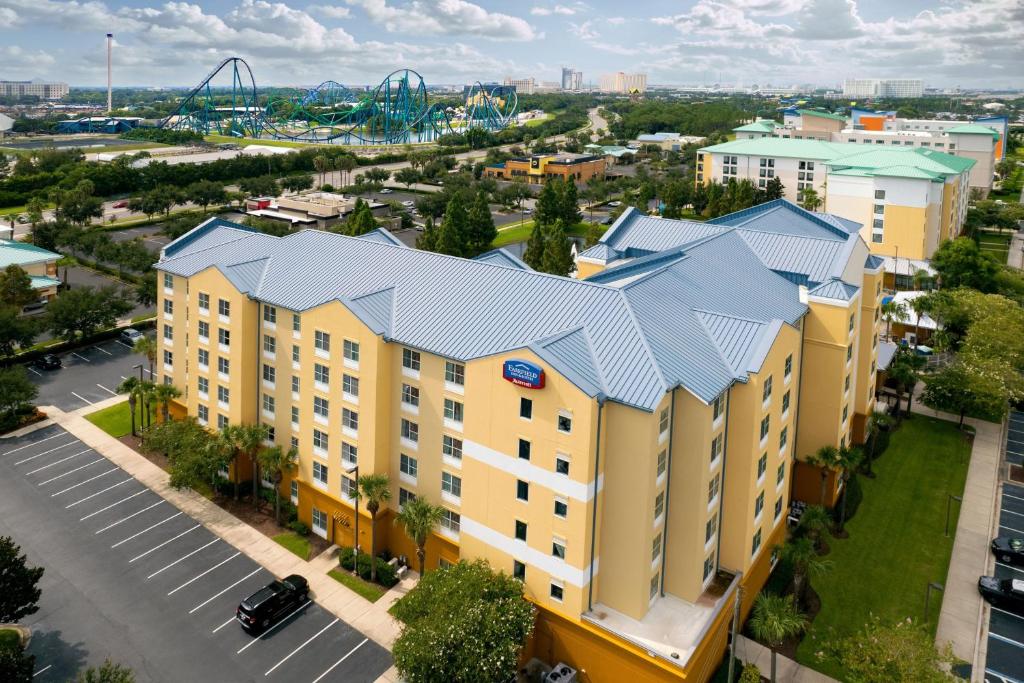 an overhead view of a building with a roller coaster in the background at Fairfield Inn Suites by Marriott Orlando At SeaWorld in Orlando