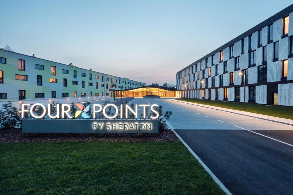 a sign that reads four points by strength on a building at Four Points by Sheraton Ljubljana Mons in Ljubljana