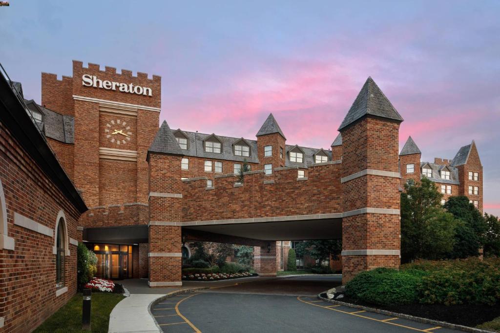 a large brick building with a clock on it at Sheraton Parsippany Hotel in Parsippany