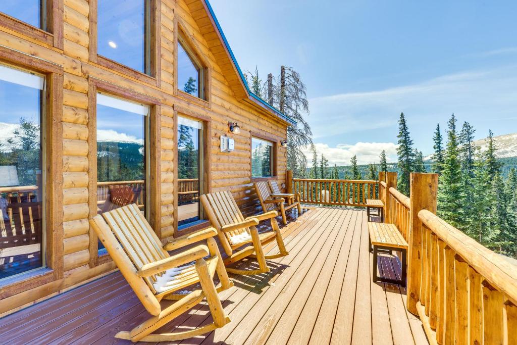 a log cabin deck with chairs and windows at Family-Friendly Fairplay Cabin with Deck and Mtn Views in Fairplay