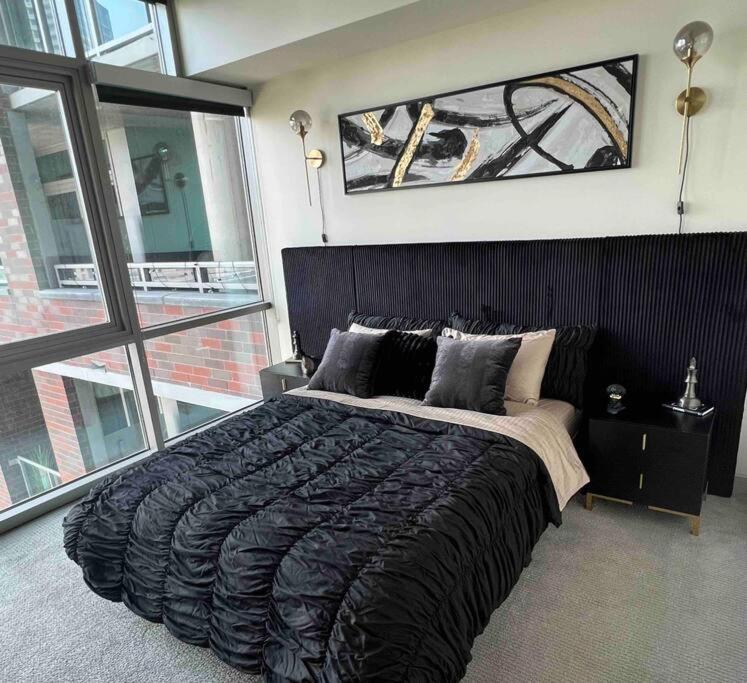 a bedroom with a large bed with a large window at Opulence is a way of life in Dallas