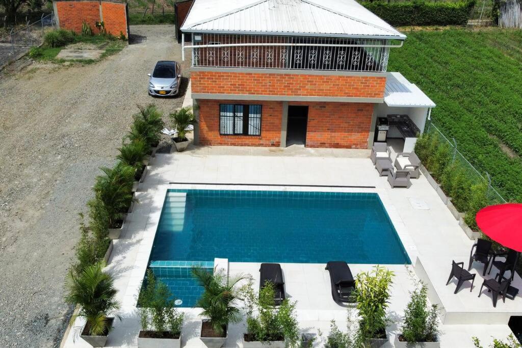 an overhead view of a swimming pool in front of a house at Villa Santho 