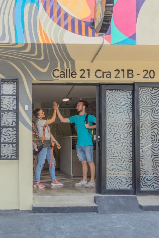 two men standing in the doorway of a building at Ventiuna Hotel y Coliving in Pereira