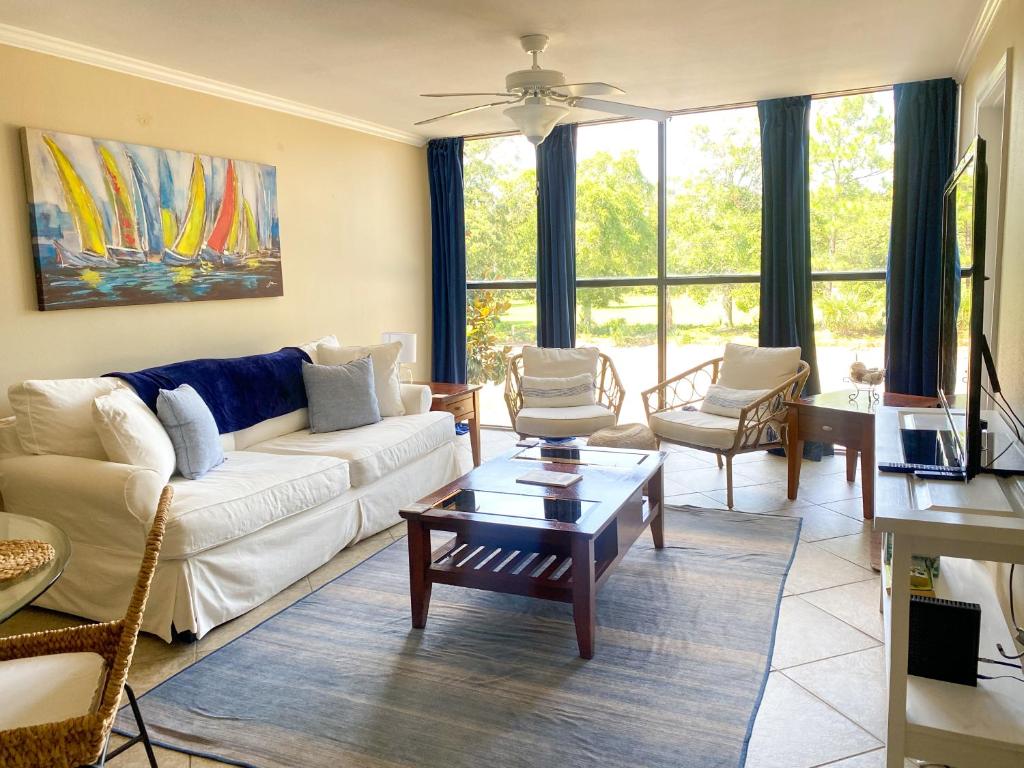 a living room with a couch and a table at Fun 2 bed/2 bath condo with pool on Biloxi Beach in Biloxi