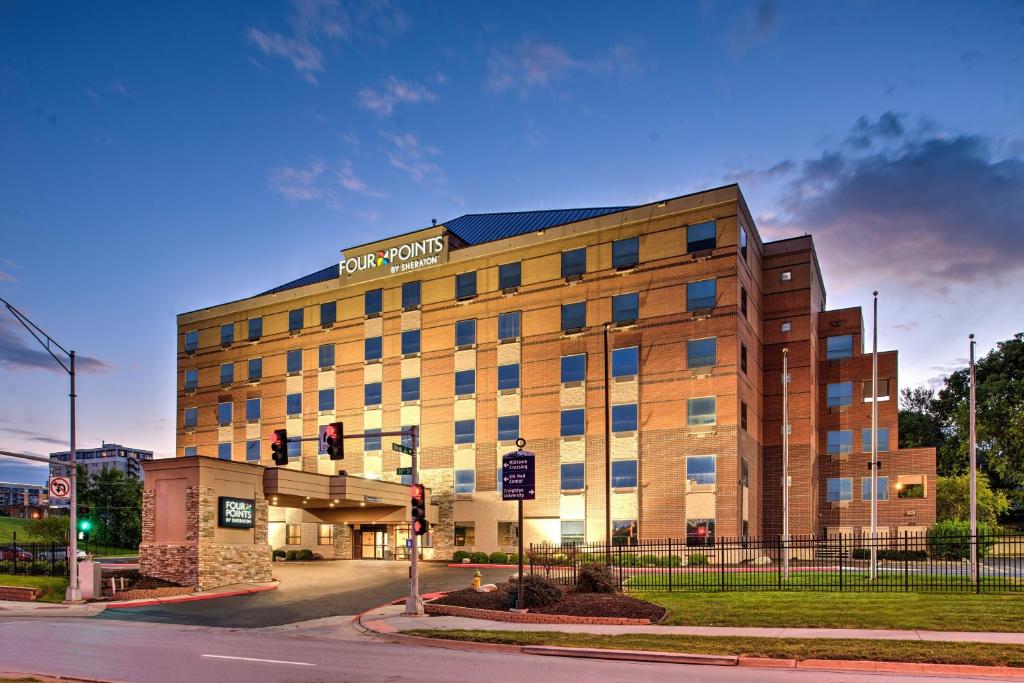 a building with a sign on the side of it at Four Points by Sheraton Omaha Midtown in Omaha