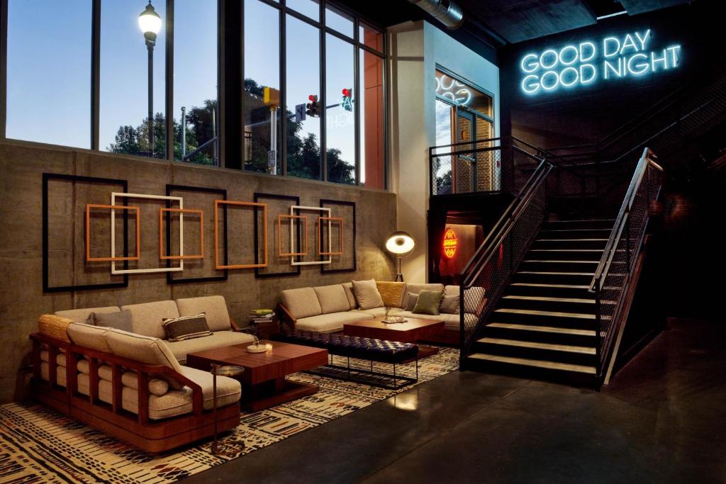 a lobby of a hotel with a couch and a table at The Casso, Raleigh, a Tribute Portfolio Hotel in Raleigh