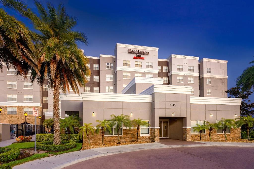 a hotel with a palm tree in front of it at Residence Inn Melbourne in Melbourne