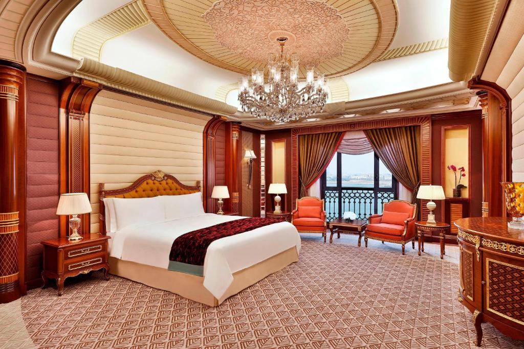a hotel room with a bed and a chandelier at The Ritz-Carlton Jeddah in Jeddah