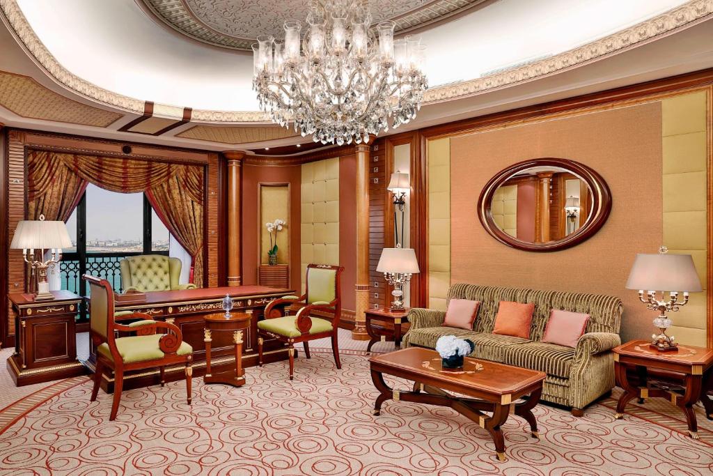 a living room with a chandelier and a living room at The Ritz-Carlton Jeddah in Jeddah