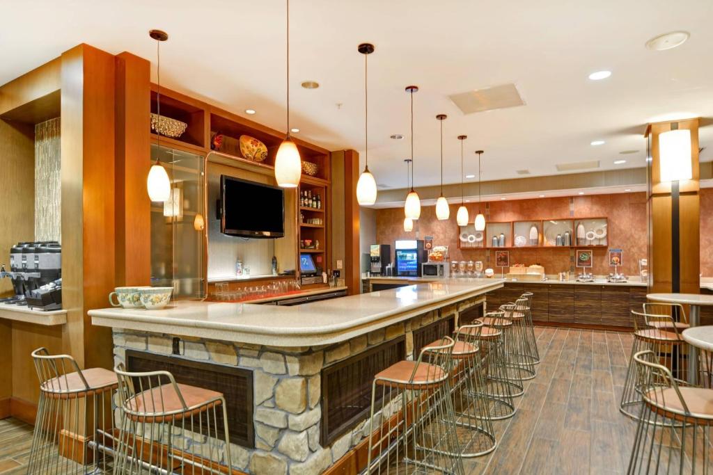 a bar in a restaurant with a bunch of chairs at SpringHill Suites Denver at Anschutz Medical Campus in Aurora