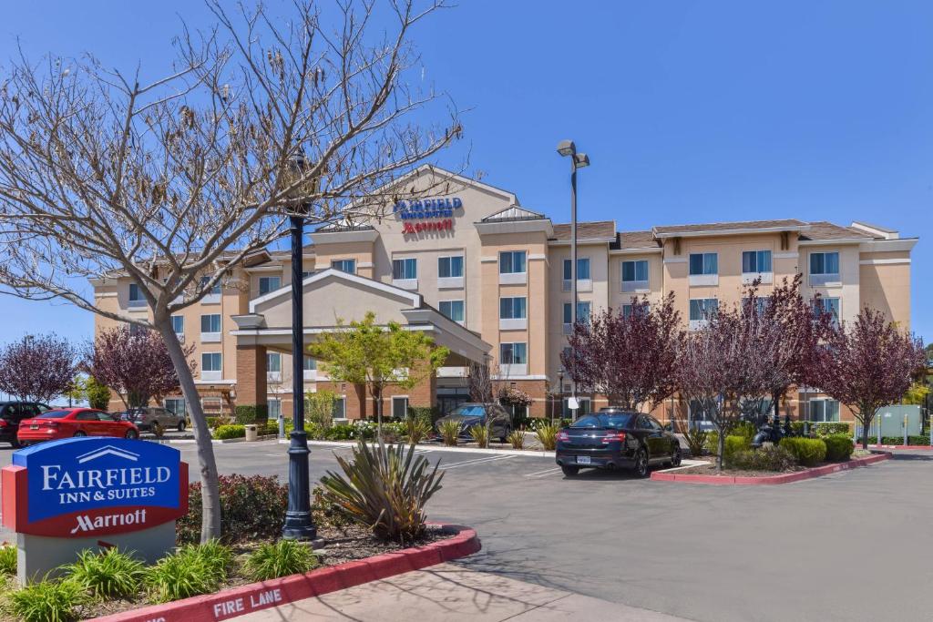 a hotel with a sign in front of a parking lot at Fairfield Inn & Suites Santa Maria in Santa Maria