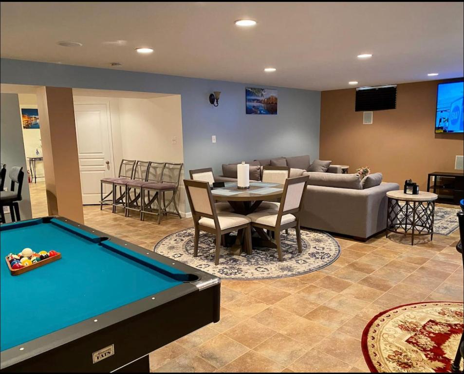 a living room with a pool table and a couch at Van Gogh Guest Rm#6 • Van Gogh 6- Private BSMT Rm in single family home in Rosedale
