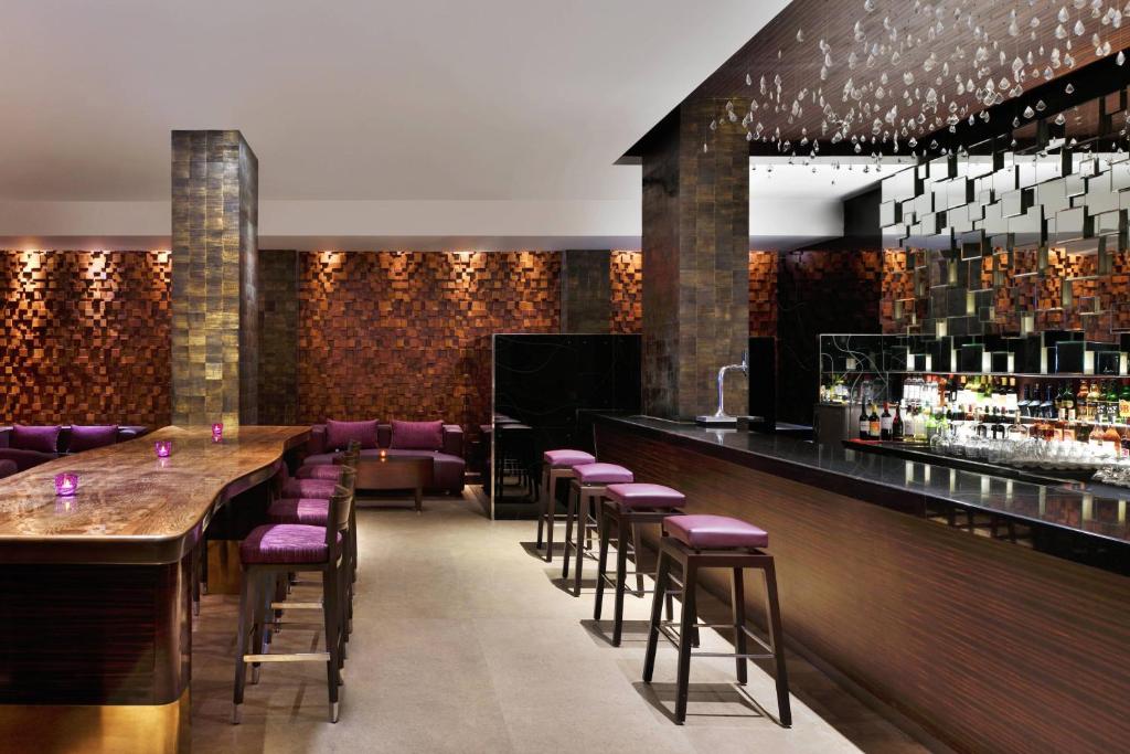 a bar with purple stools in a restaurant at Courtyard by Marriott Chennai in Chennai