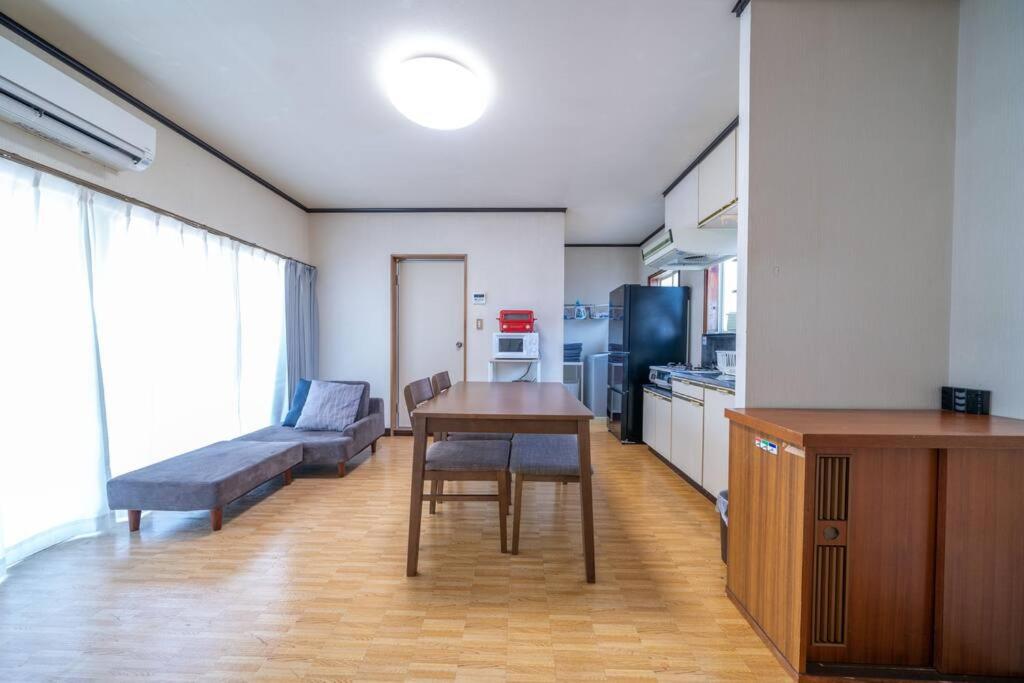 a kitchen with a table and a couch in a room at コーポセキヤ / Corp Sekiya in Itoigawa