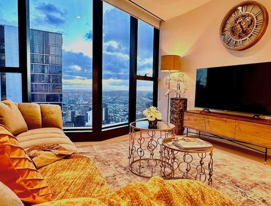 a living room with a television and a large window at Highrise view 1king1Queen 2baths in Melbourne