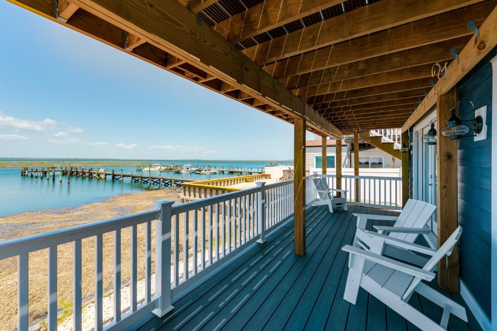 a porch with two chairs and a view of the water at Brigantine Waterfront Vacation Rental with Grill in Brigantine