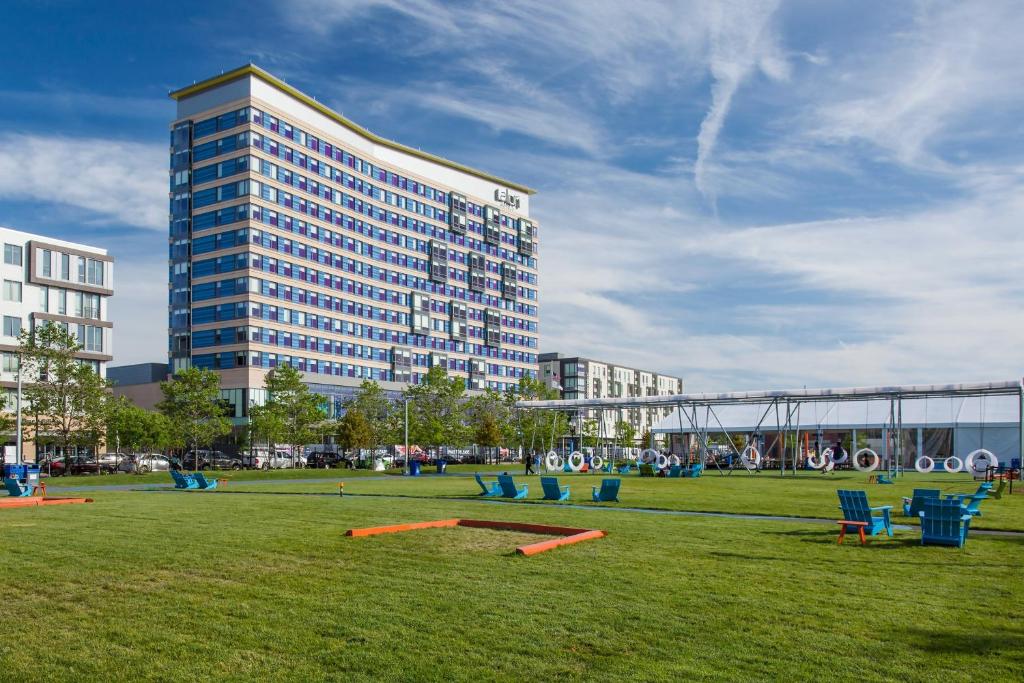 a large building with a large field with blue chairs at Aloft Boston Seaport District in Boston