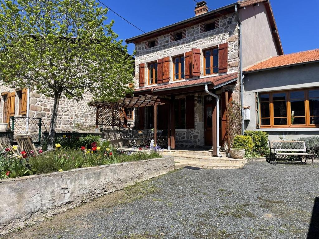 an old stone house with a bench in front of it at Gîte Laprugne, 3 pièces, 6 personnes - FR-1-489-448 in Laprugne