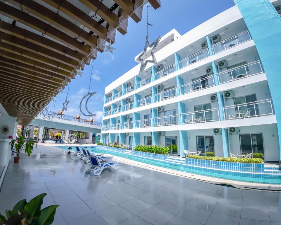 a large building with a swimming pool in front of it at Bohol Dolphin Bay Resort in Panglao