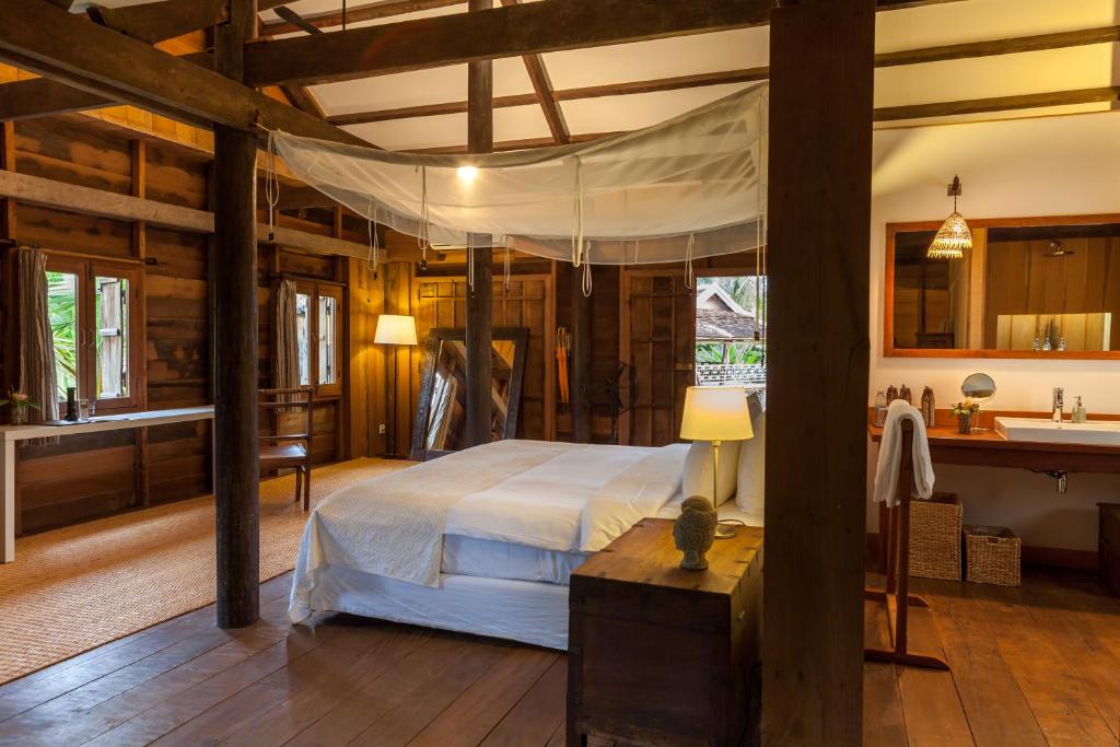 a bedroom with a bed and a sink in a room at Sala Lodges in Siem Reap