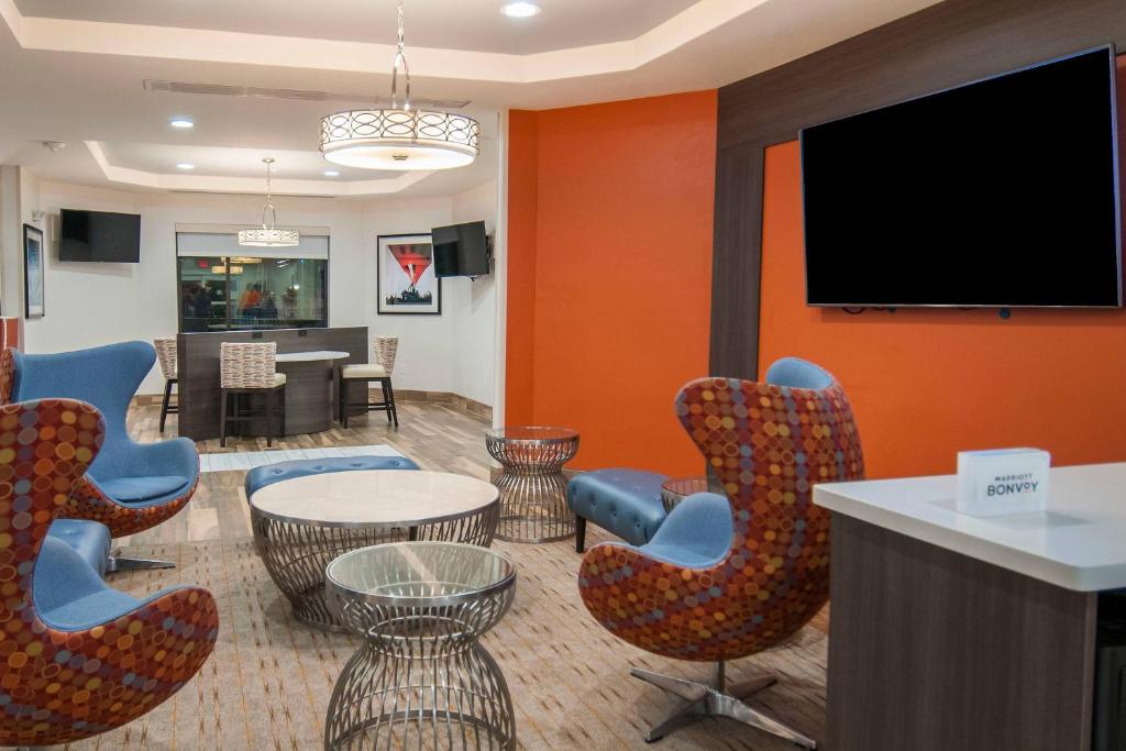 a waiting room with chairs and a flat screen tv at TownePlace Suites by Marriott Vidalia Riverfront in Vidalia