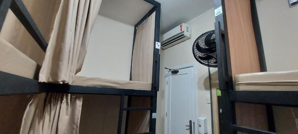 a room with a bunk bed and a mirror at Hostel Leblon in Rio de Janeiro